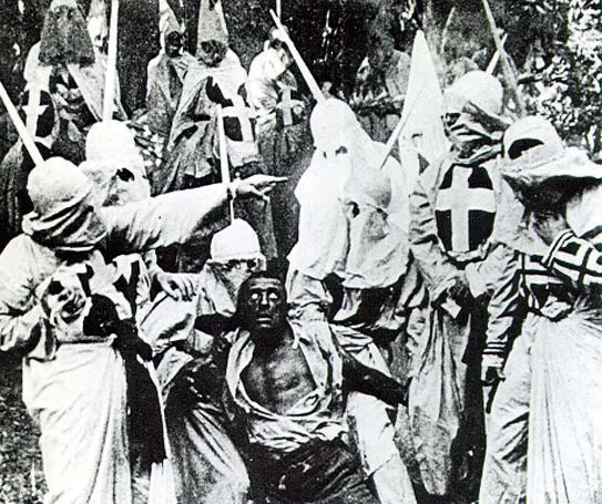A scene from the movie Birth of a Nation (1915). Hooded Klansmen catch Gus, a black man portrayed in blackface by actor Walter Long.